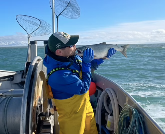 Juro Kusnir kissing a Copper River sockeye salmon