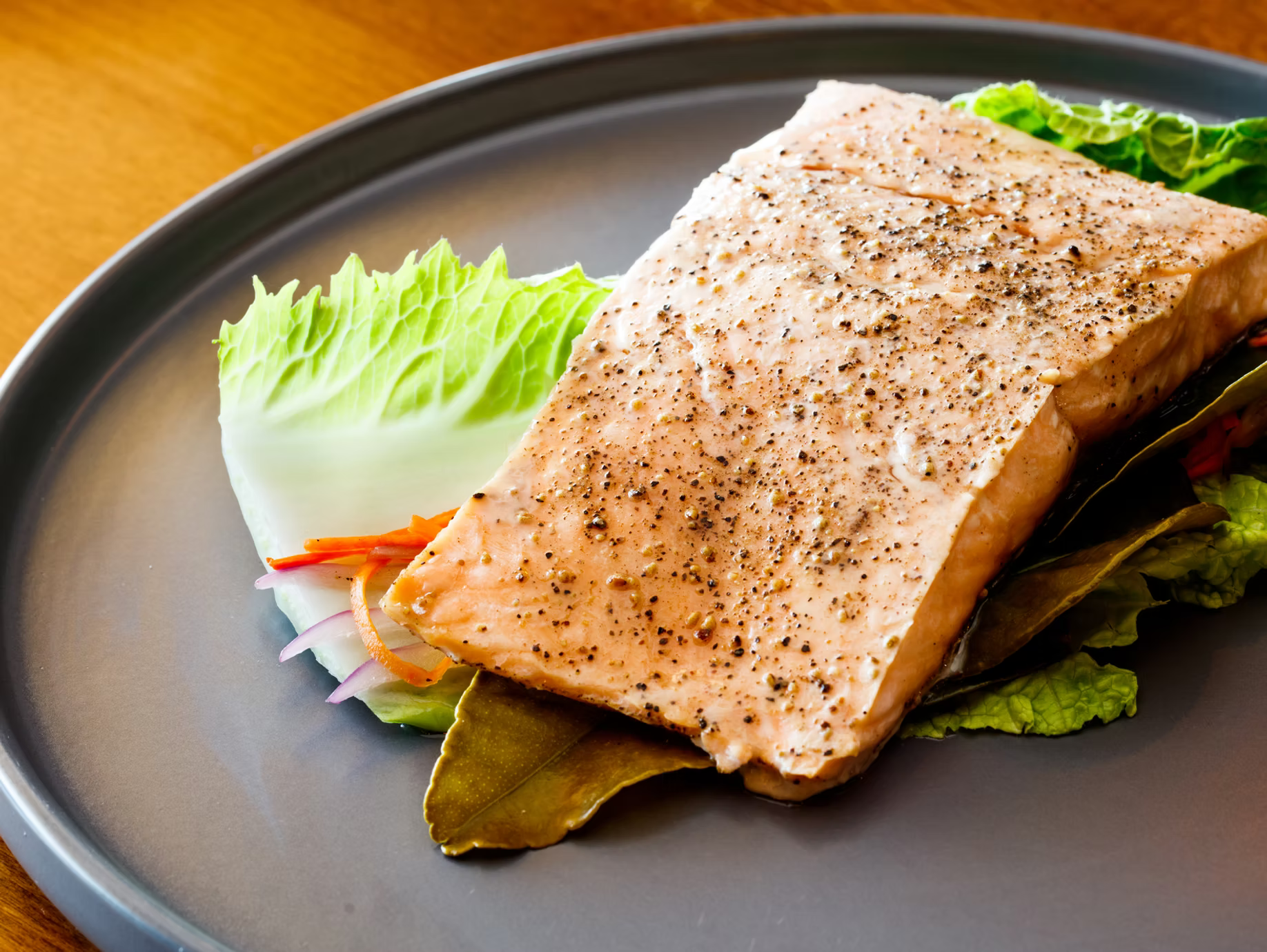 Fresh Alaskan wild fish plated on a bed of greens