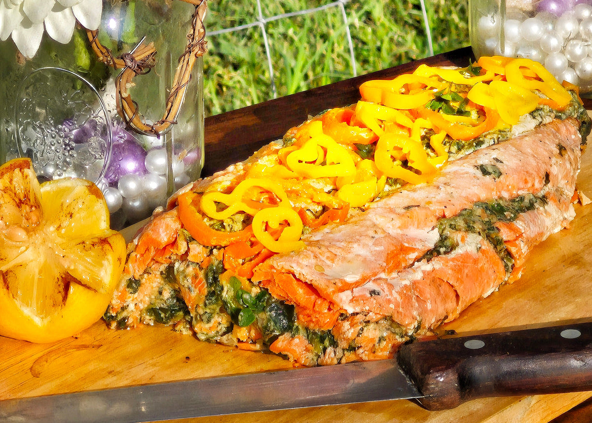 stuffed sockeye salmon with garlic and mushroom, herbs, spinach and sweet peppers