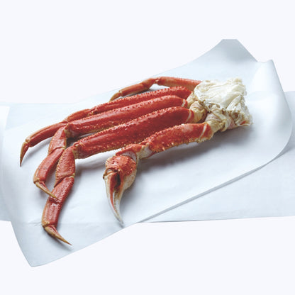 Bairdi Snow Crab cluster placed on a white sheet of parchment paper.